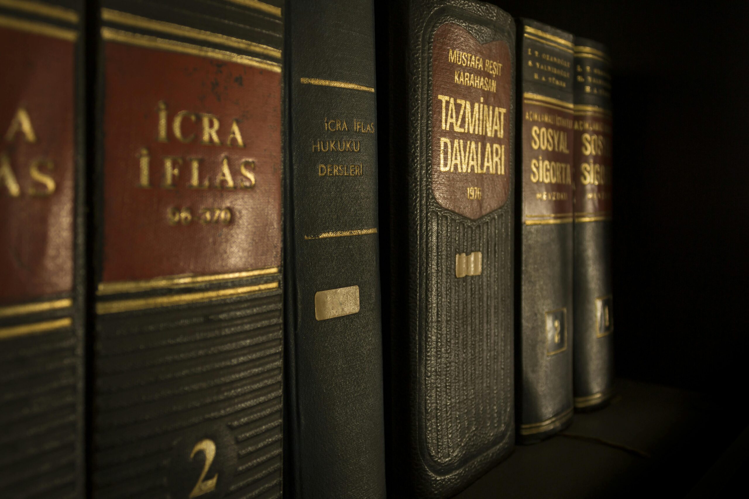 Detailed close-up of law and regulation books on a bookshelf, emphasizing education and knowledge.